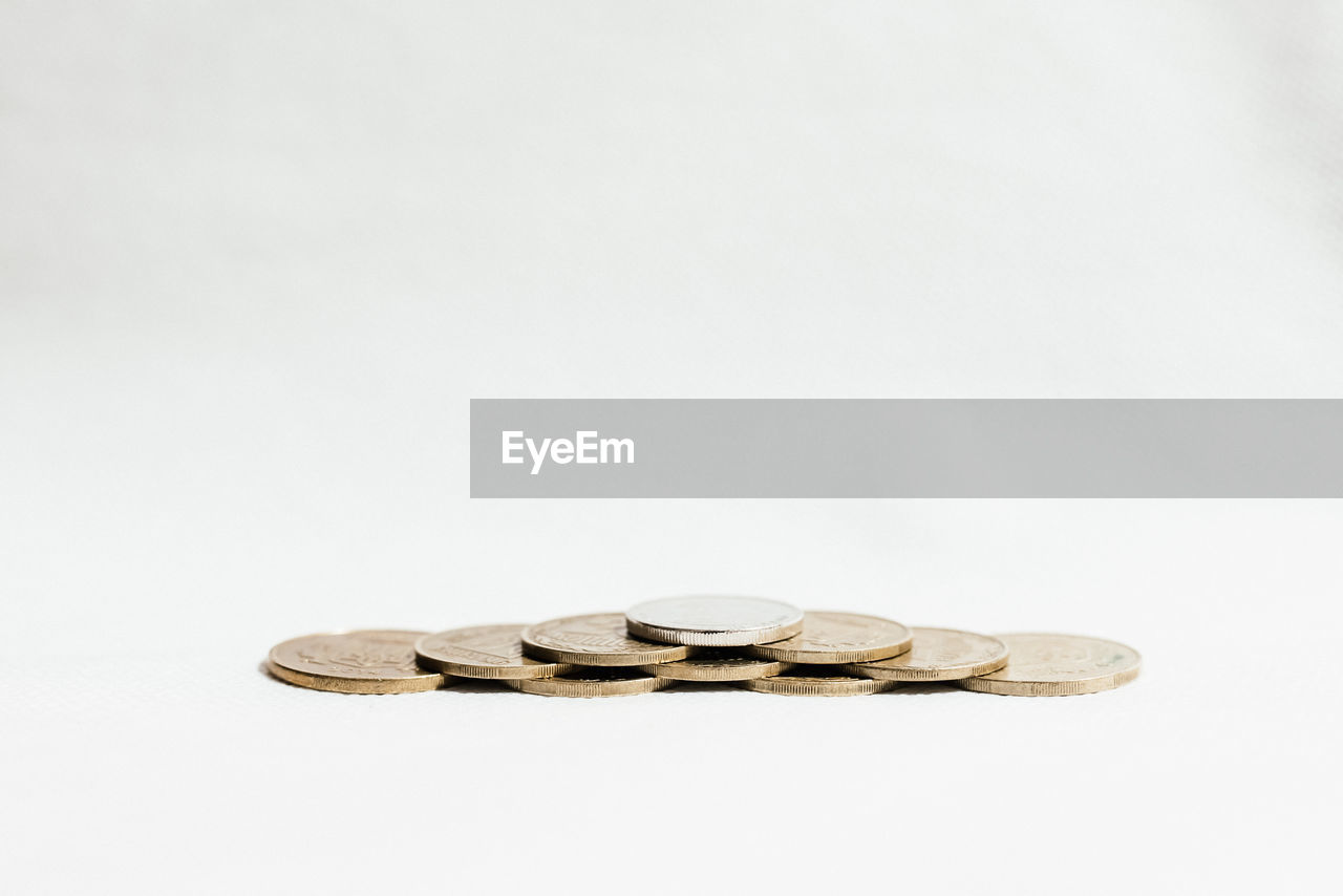 Close-up of coins on white background