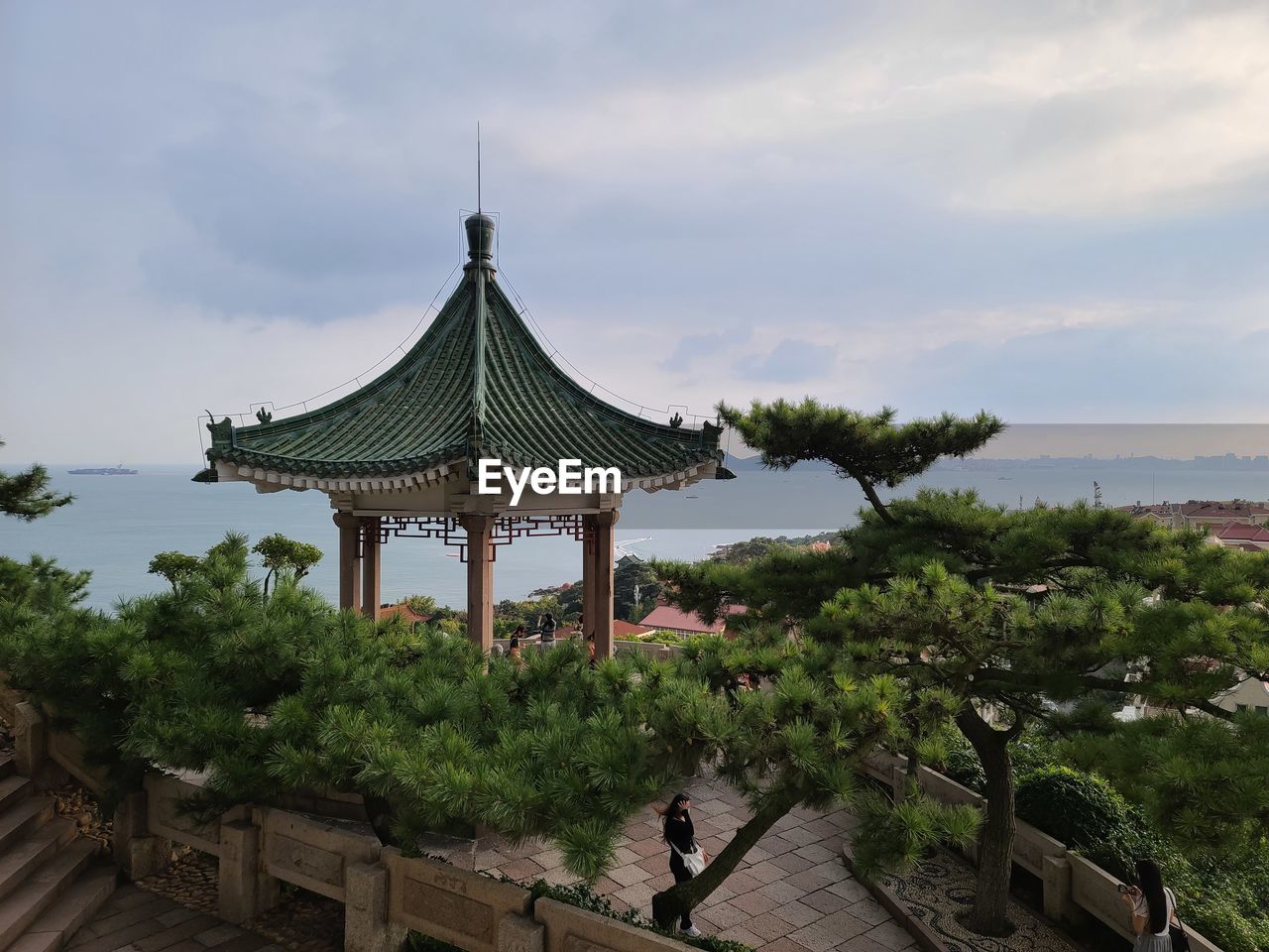 Temple by building against sky