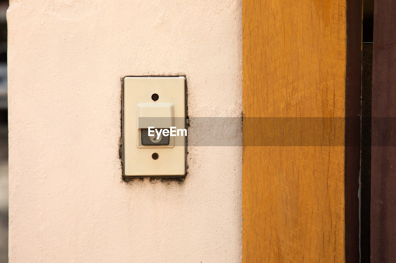 CLOSE-UP OF ELECTRIC LIGHT ON WALL