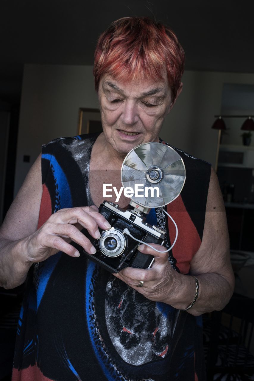 Portrait of woman photographing