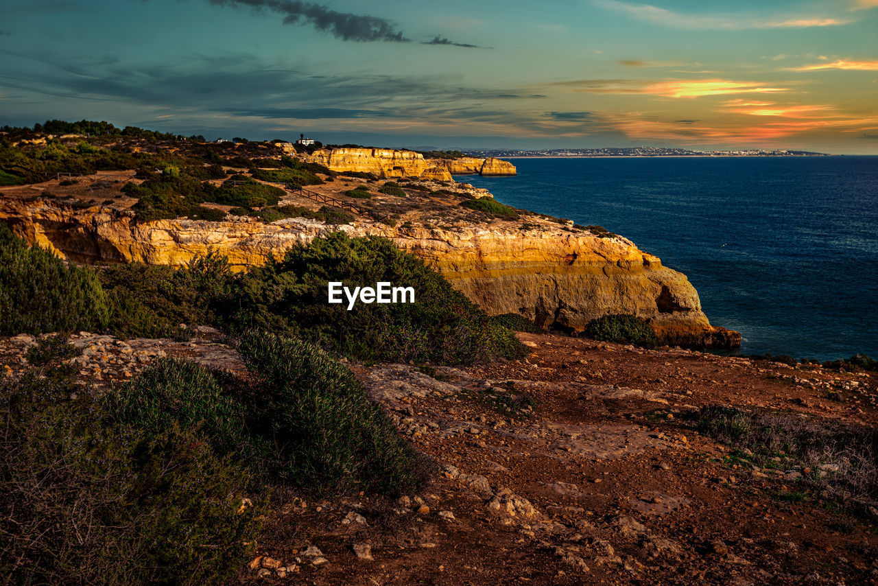 sea, sky, coast, water, rock, land, scenics - nature, nature, beauty in nature, sunset, cliff, beach, ocean, horizon, landscape, cloud, shore, environment, travel destinations, tranquility, terrain, no people, dusk, coastline, horizon over water, travel, tranquil scene, evening, seascape, outdoors, tourism, non-urban scene, plant, rock formation, idyllic, body of water, mountain, dramatic sky, reflection, bay, architecture
