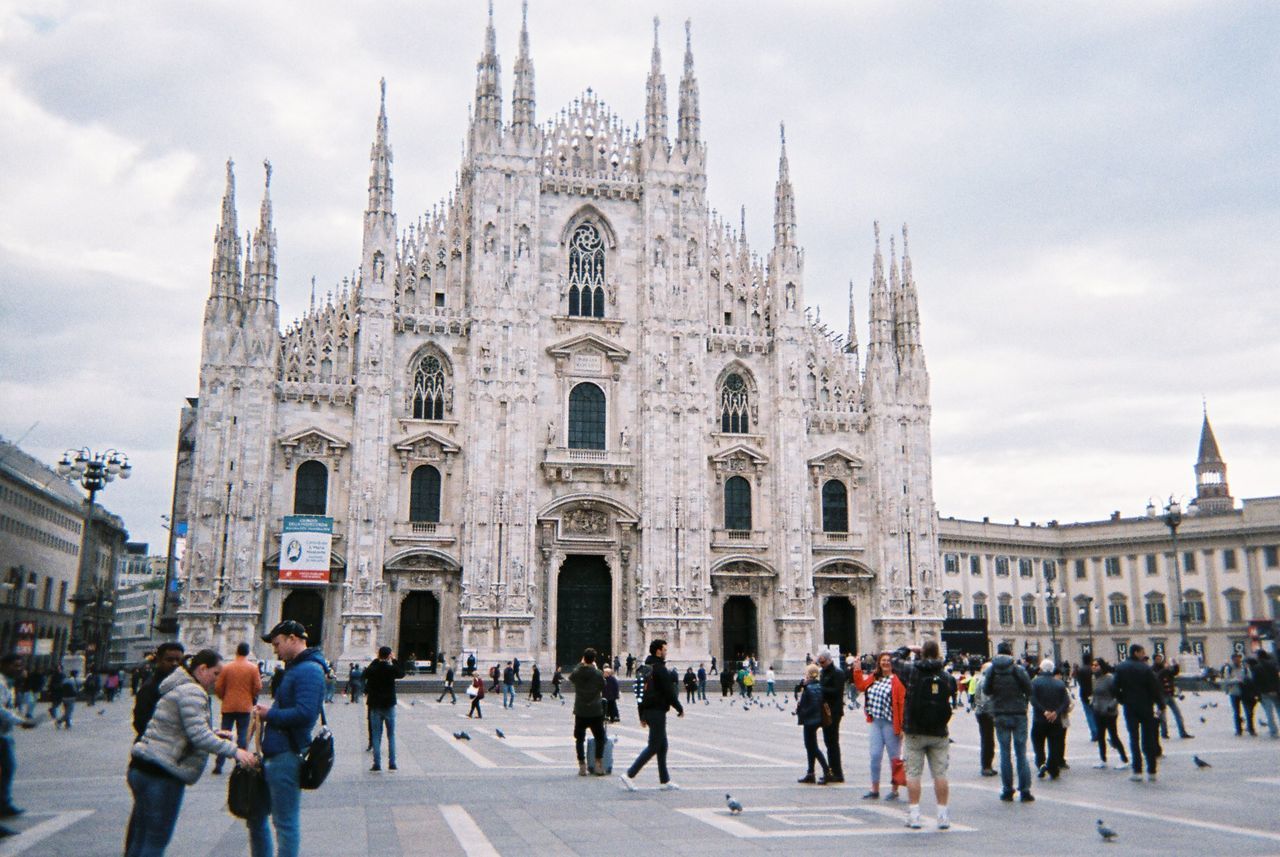 GROUP OF PEOPLE IN FRONT OF BUILDINGS