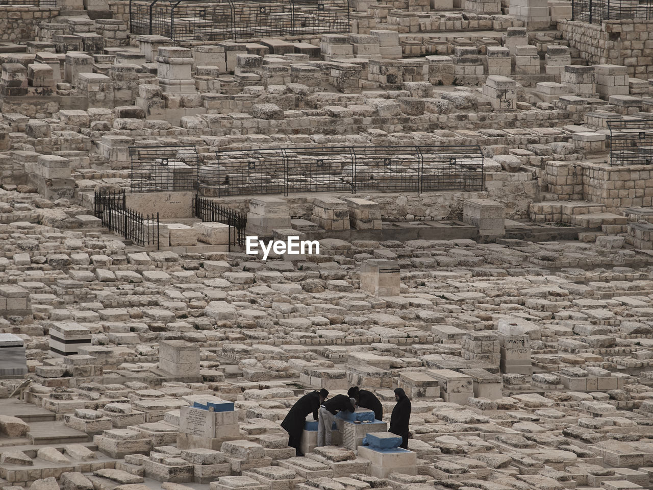 People praying amidst rocks