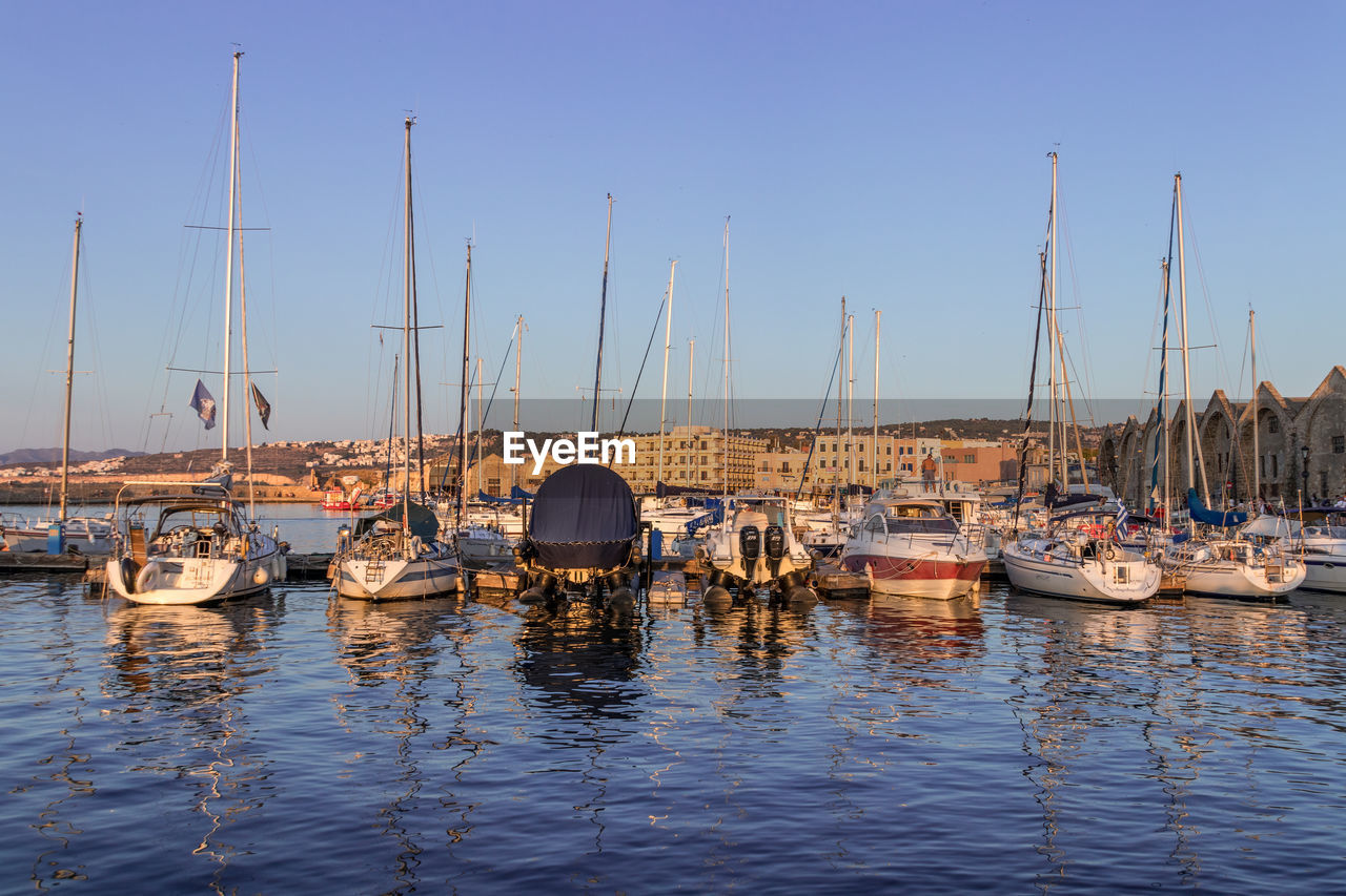 BOATS MOORED IN HARBOR AT MARINA