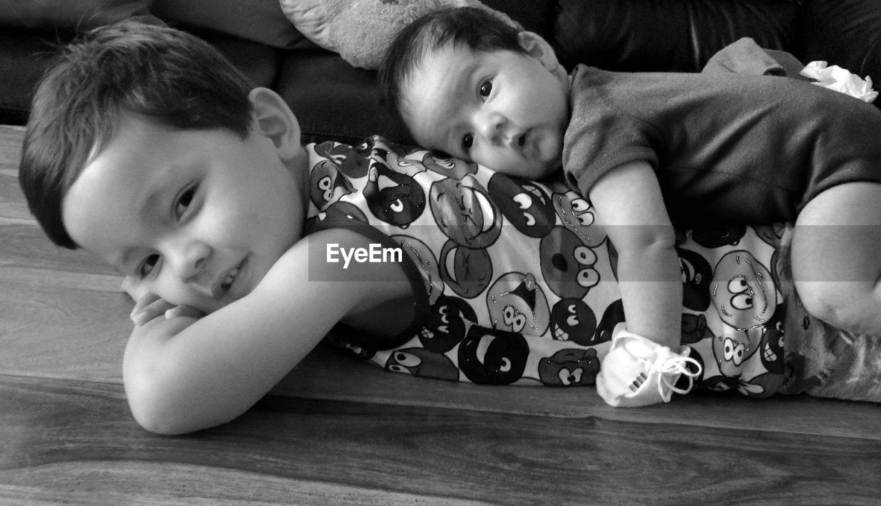 PORTRAIT OF CUTE BABY BOY ON FLOOR