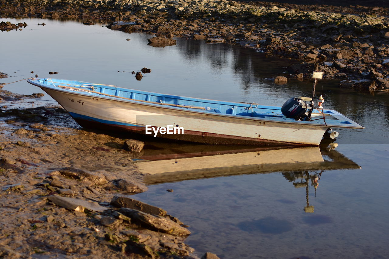 Boat moored at lake