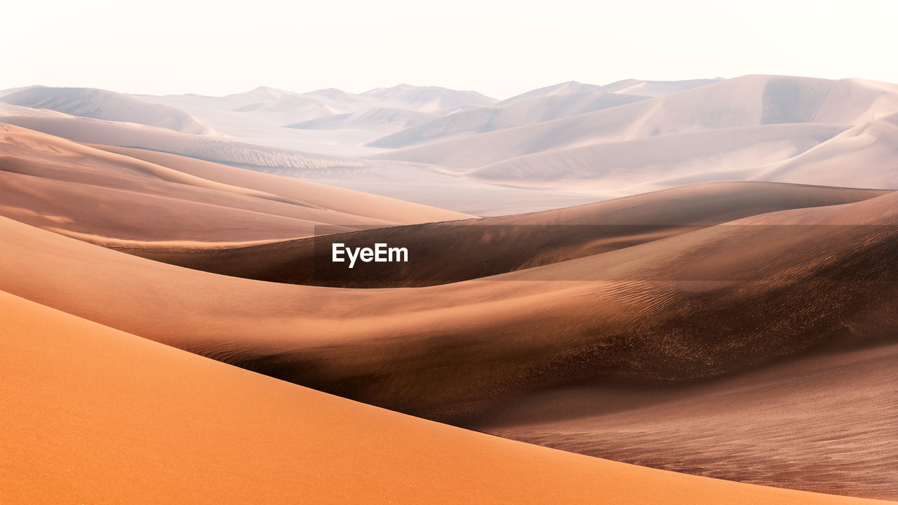 Nature and landscapes of dasht e lut or sahara desert with sand dunes in foreground and hazy sky
