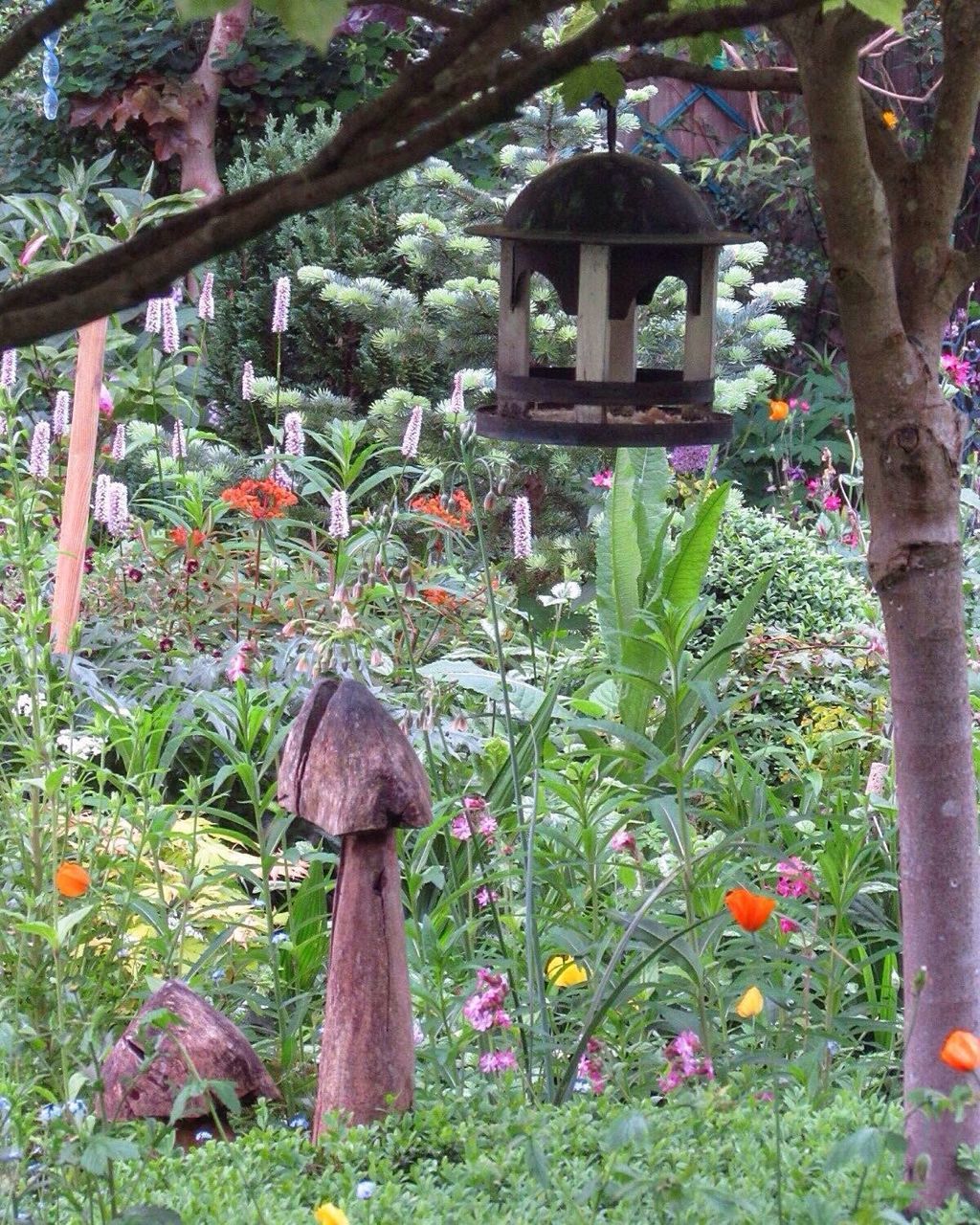 CLOSE-UP OF FLOWERS AGAINST TREES AND TEMPLE