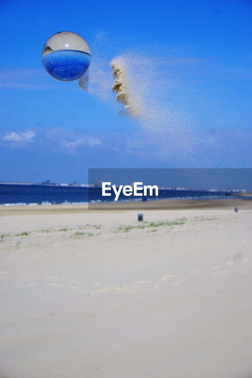 HOT AIR BALLOON FLYING OVER BEACH