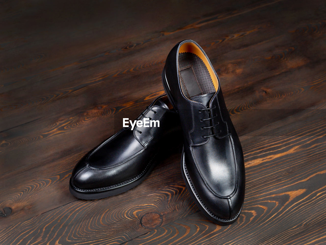 HIGH ANGLE VIEW OF SHOES ON WOODEN TABLE