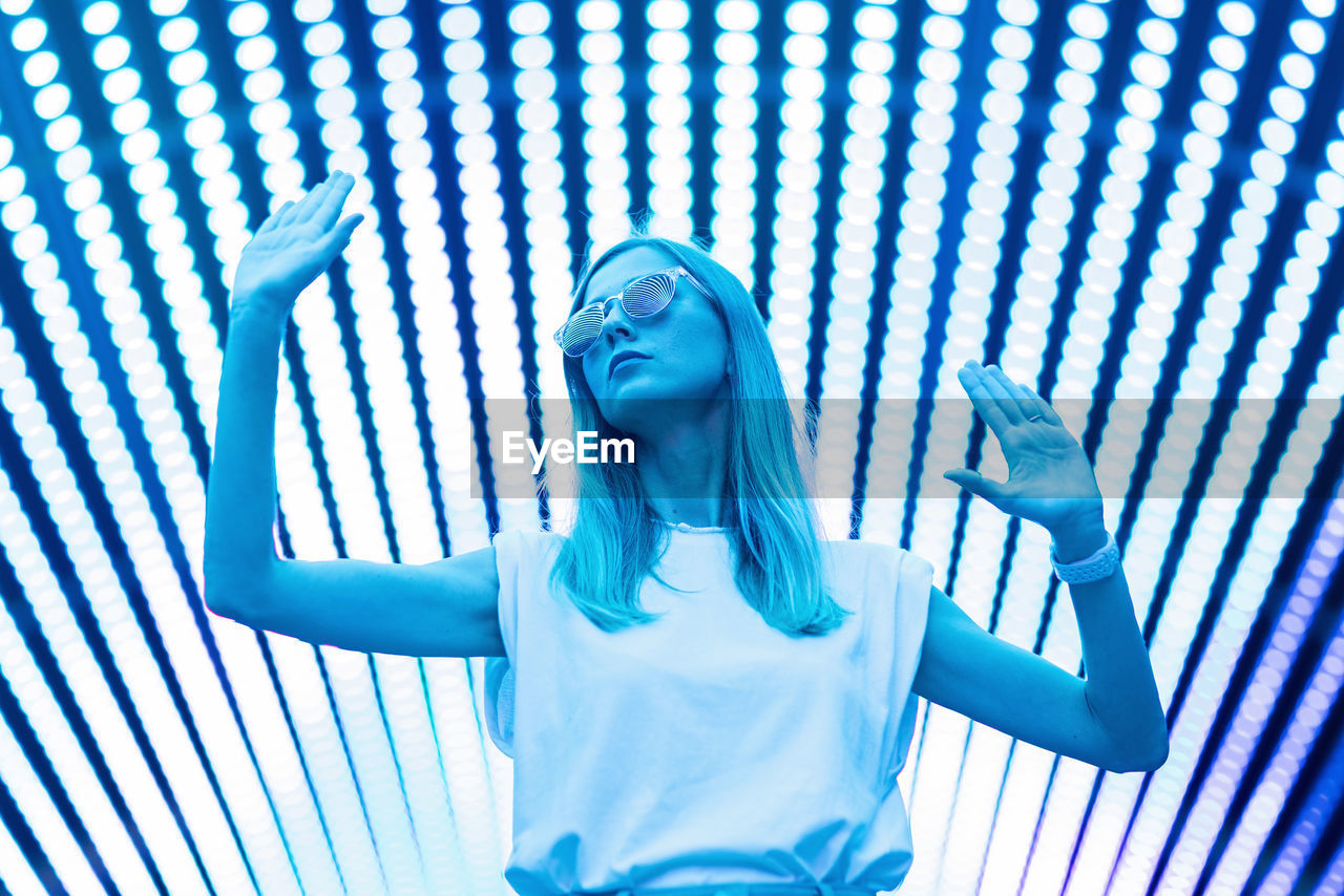 Low angle view of woman standing against wall