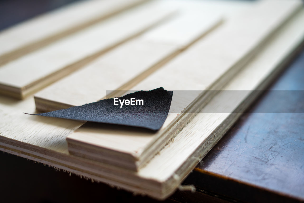 Close-up of sand paper with wood in workshop