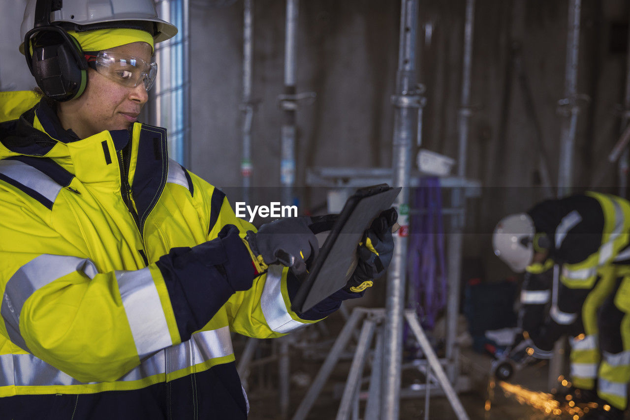 Engineer at building site using digital tablet