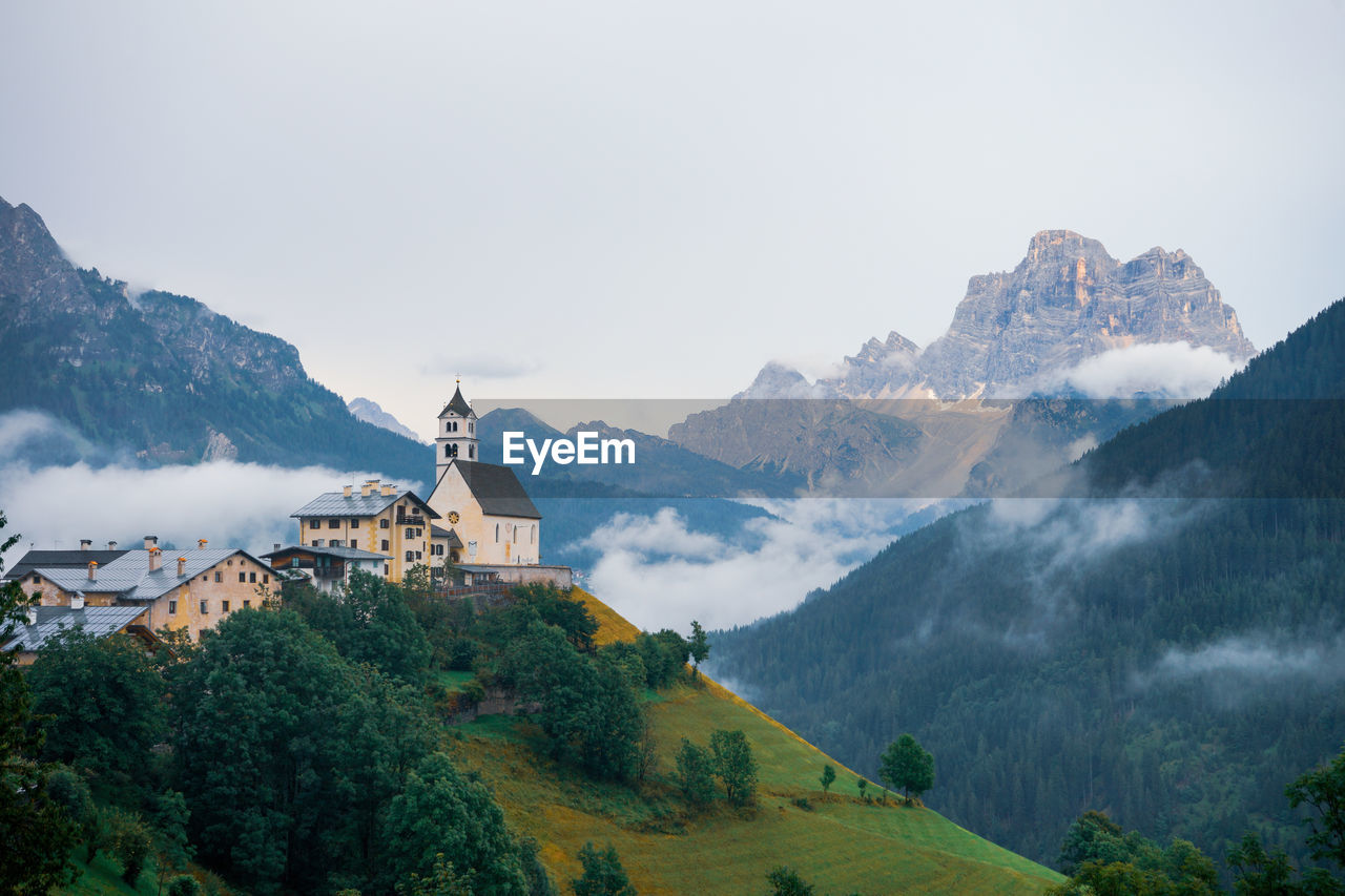 Panoramic view of buildings and mountains against sky