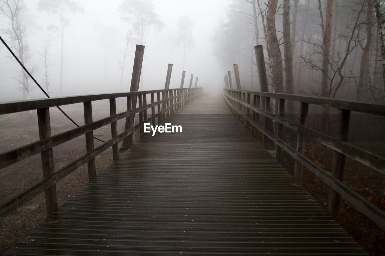 Footbridge in foggy weather during winter