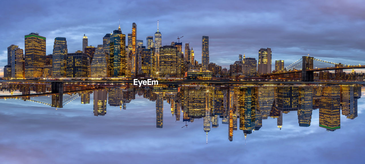 Panorama scene of new york cityscape with brooklyn bridge beside the east river at the twilight time