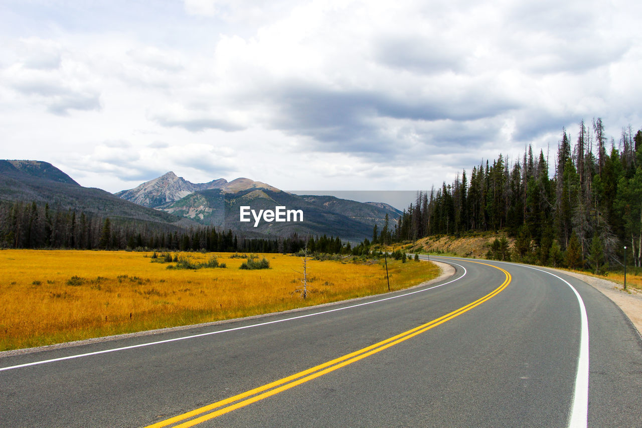 Empty road with mountains in background