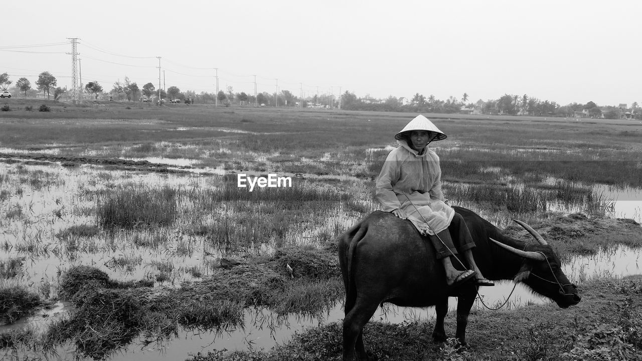 WOMAN WALKING ON FIELD