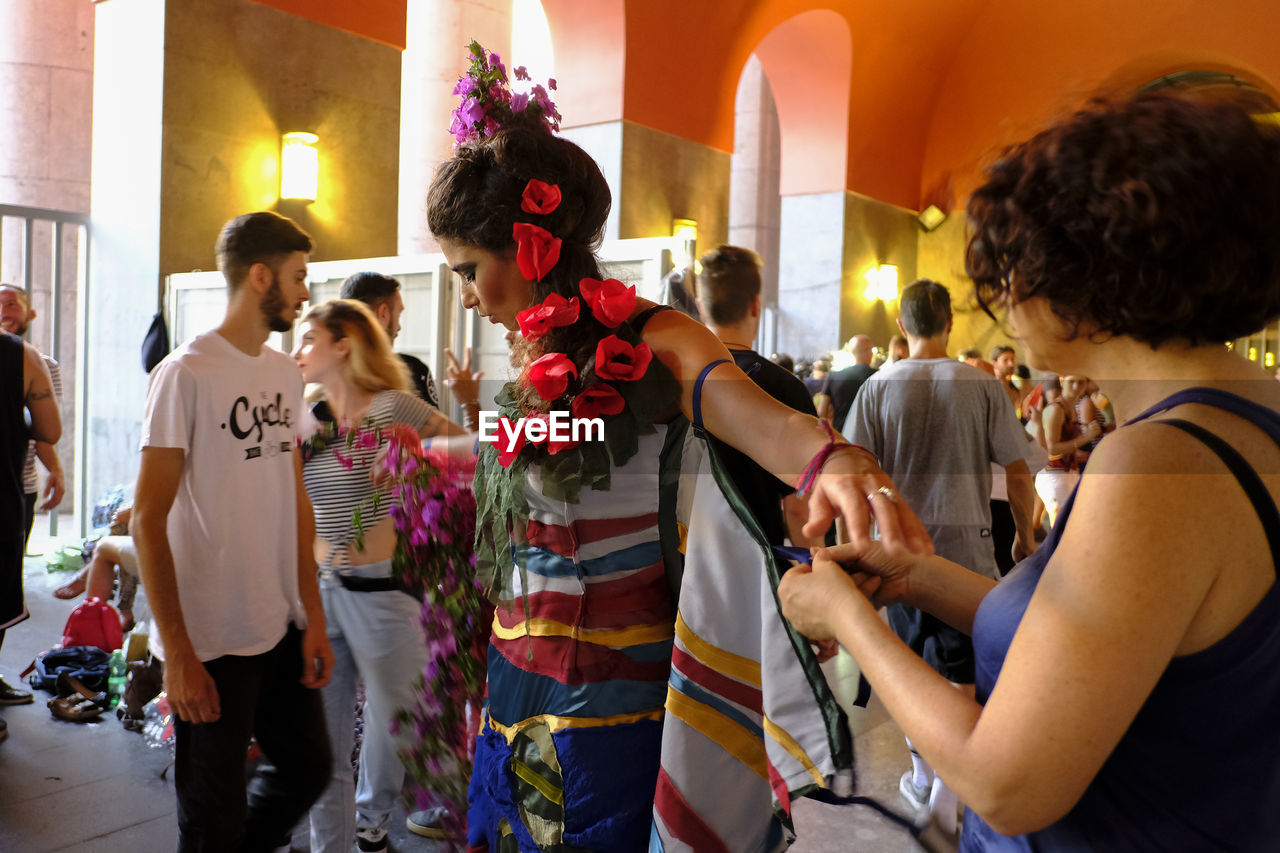 PEOPLE STANDING IN TRADITIONAL CLOTHING