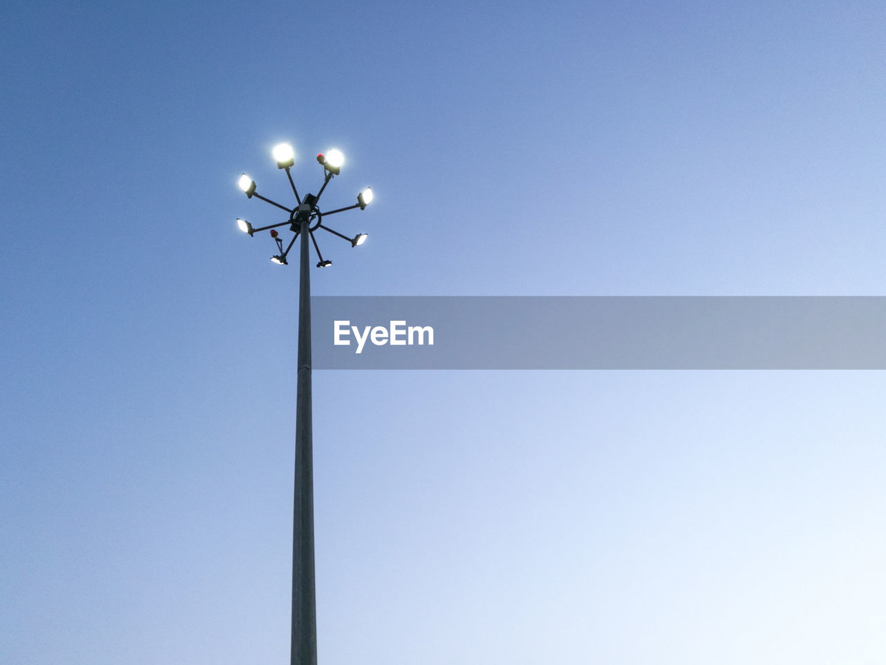 Low angle view of street light against clear blue sky