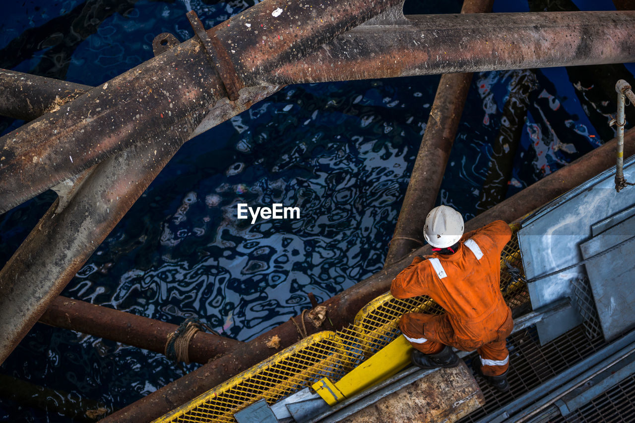 High angle view of worker offshore platform in ocean