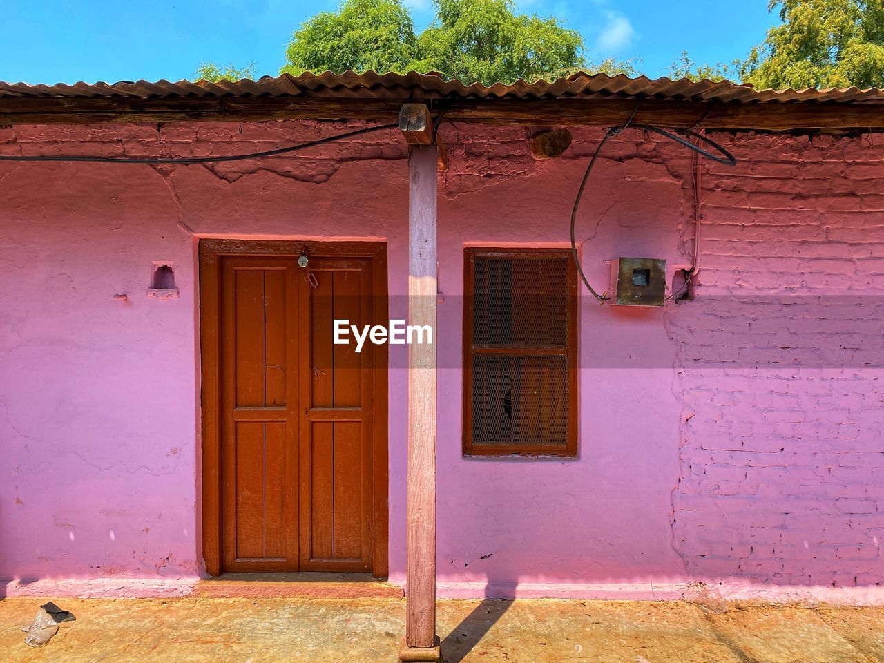 architecture, building exterior, built structure, door, entrance, building, house, residential district, window, home, no people, nature, facade, outdoors, closed, landscape, wood, plant, wall, day, city, old, rural scene, doorway, pink, village, history, red