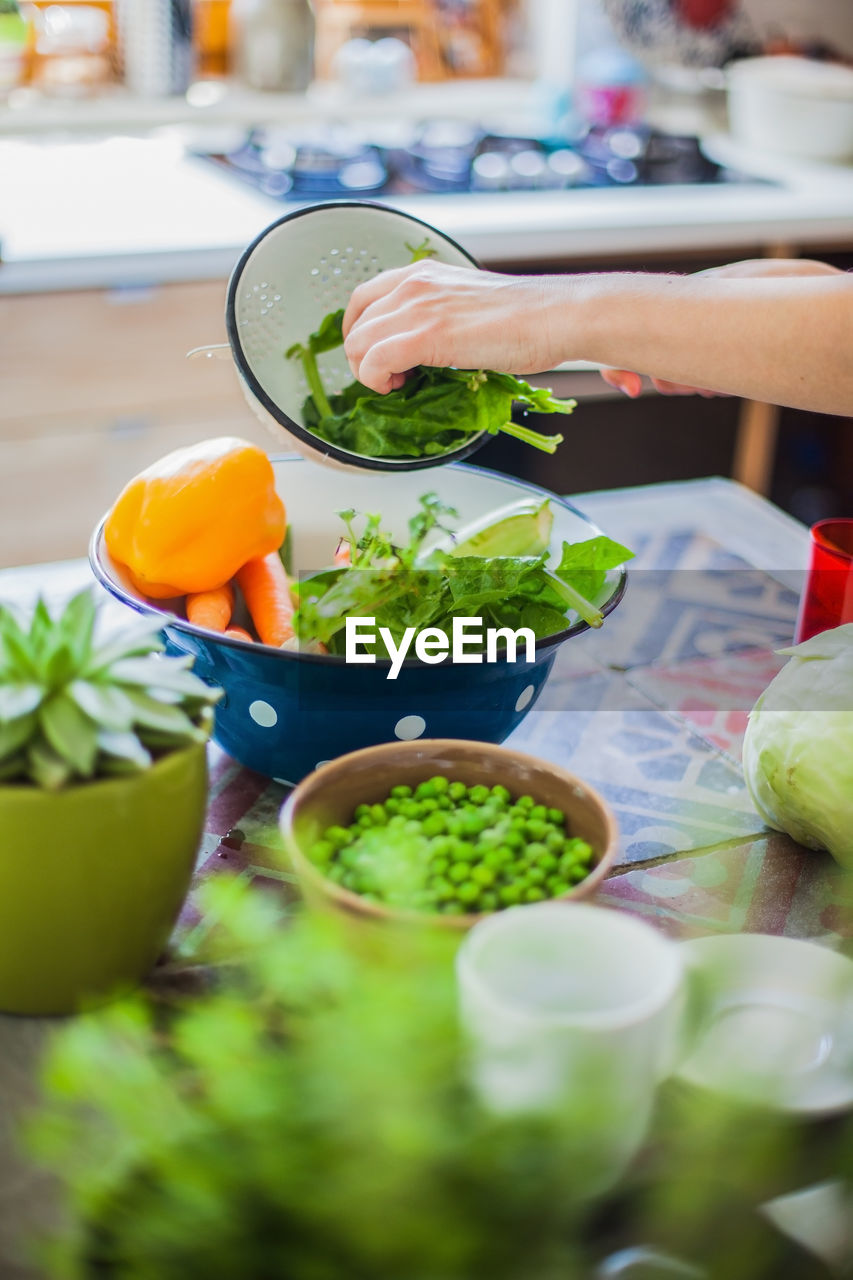 Cropped hands preparing food at home