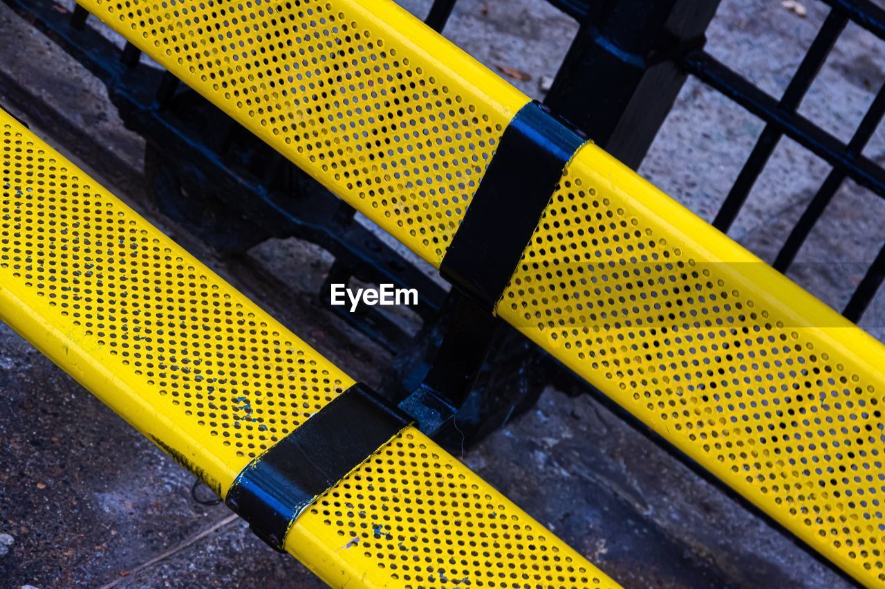 High angle view of yellow arrow symbol on road