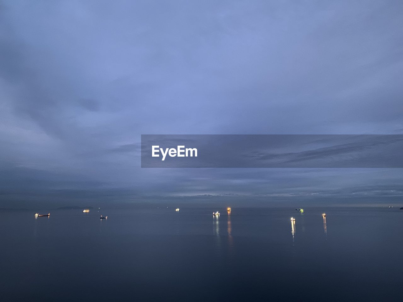 Scenic view of sea against sky at dusk