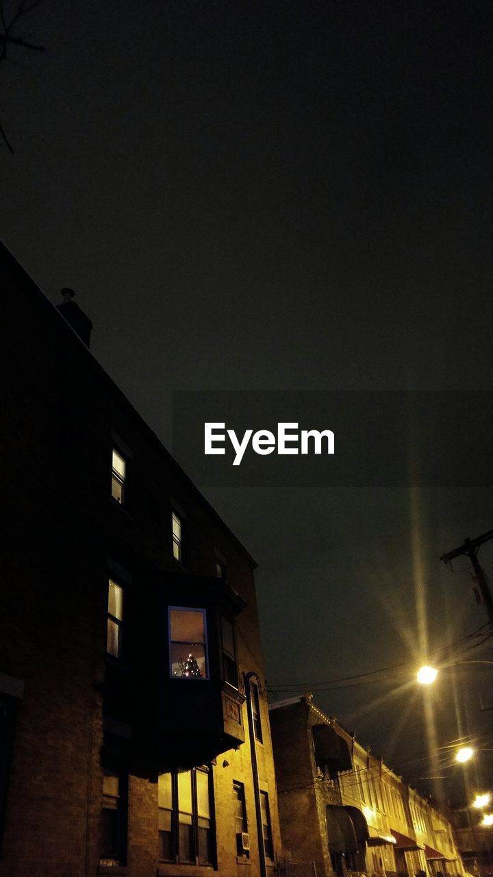 LOW ANGLE VIEW OF BUILDINGS AT NIGHT