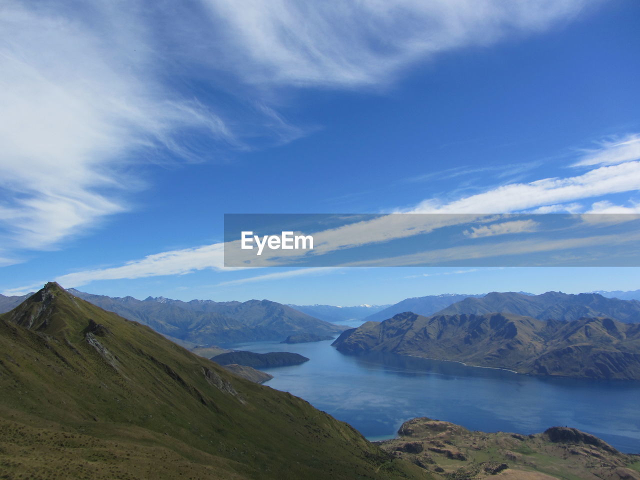 Scenic view of mountains against blue sky