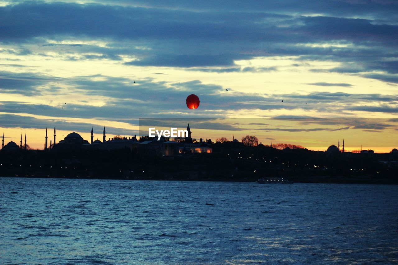 Scenic view of river against sky during sunset