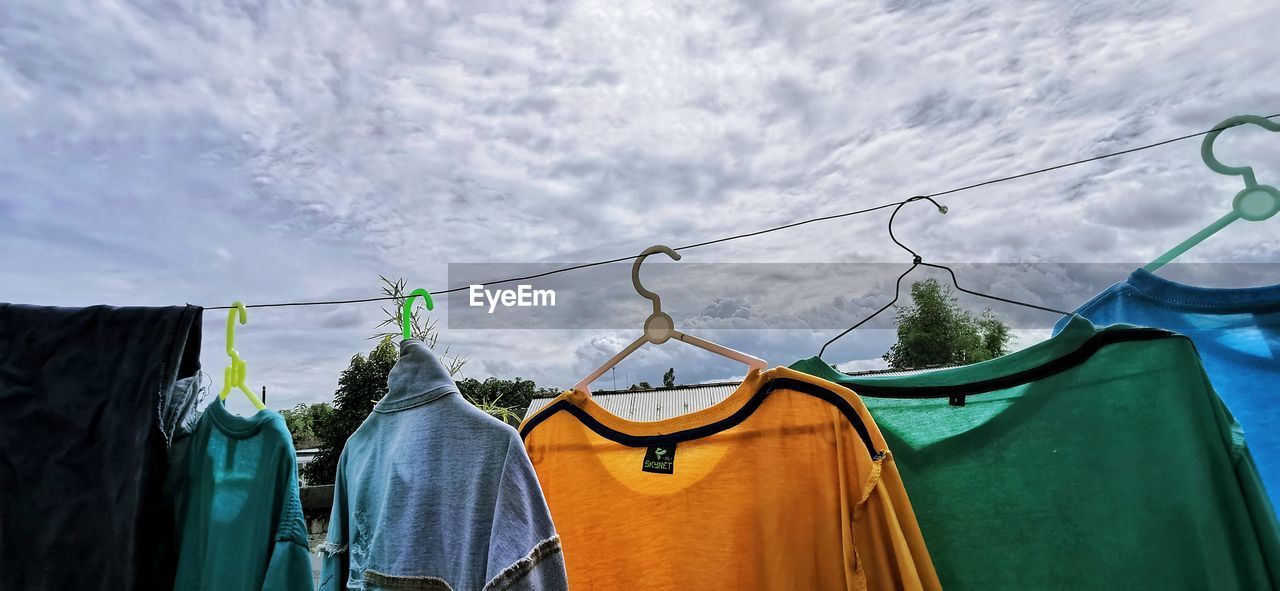 LOW ANGLE VIEW OF CLOTHES DRYING ON RACK