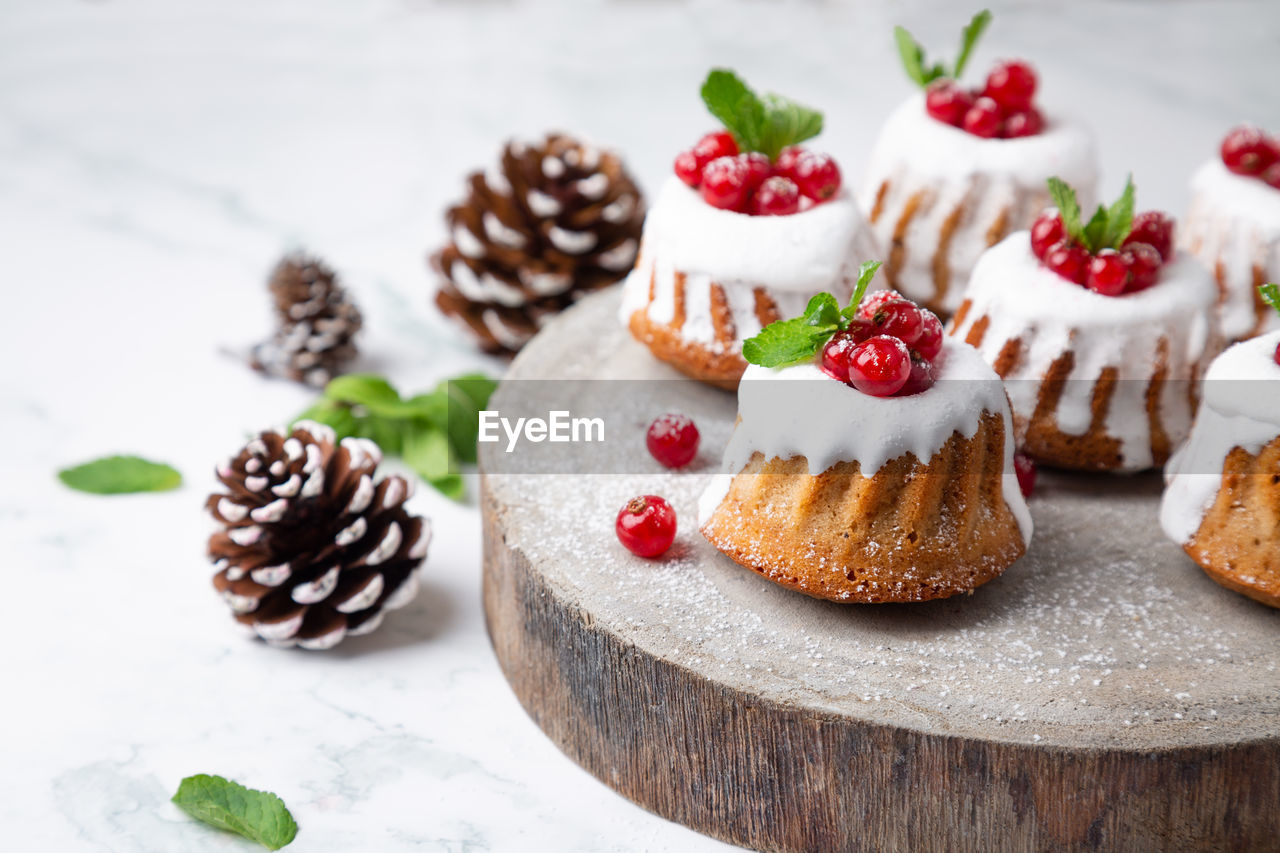 High angle view of christmas muffins with pine cones on table