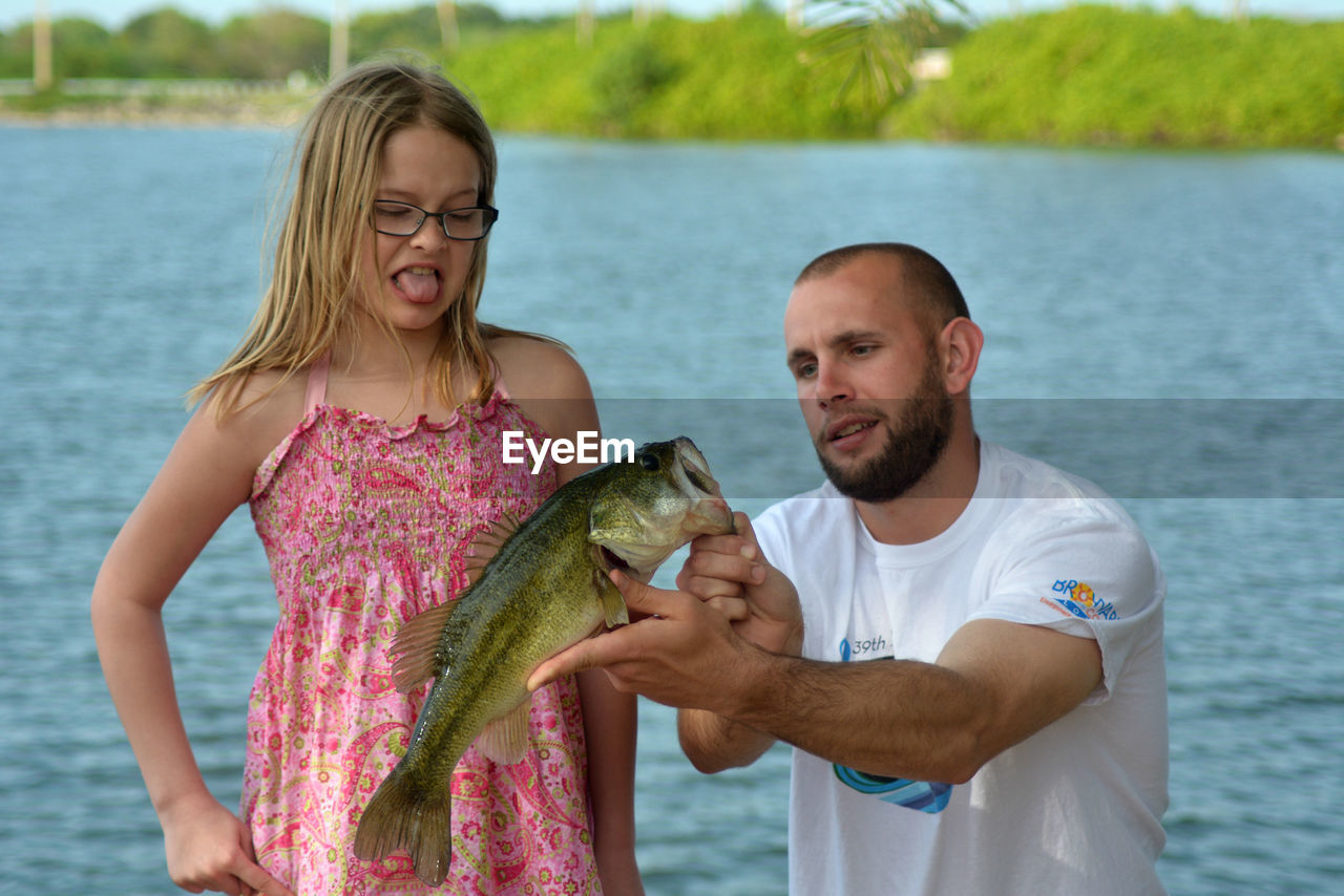 PORTRAIT OF YOUNG COUPLE IN WATER