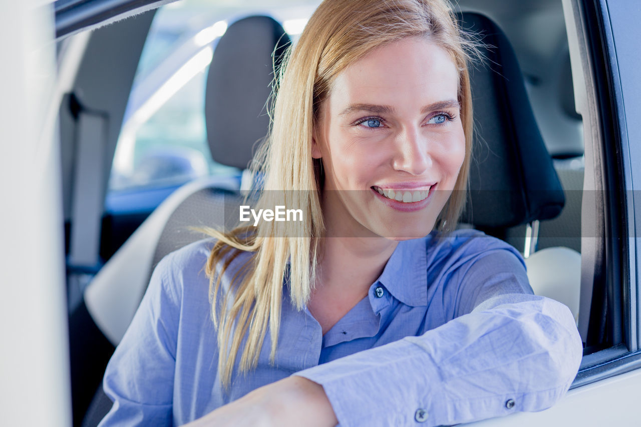 Close-up of woman sitting car