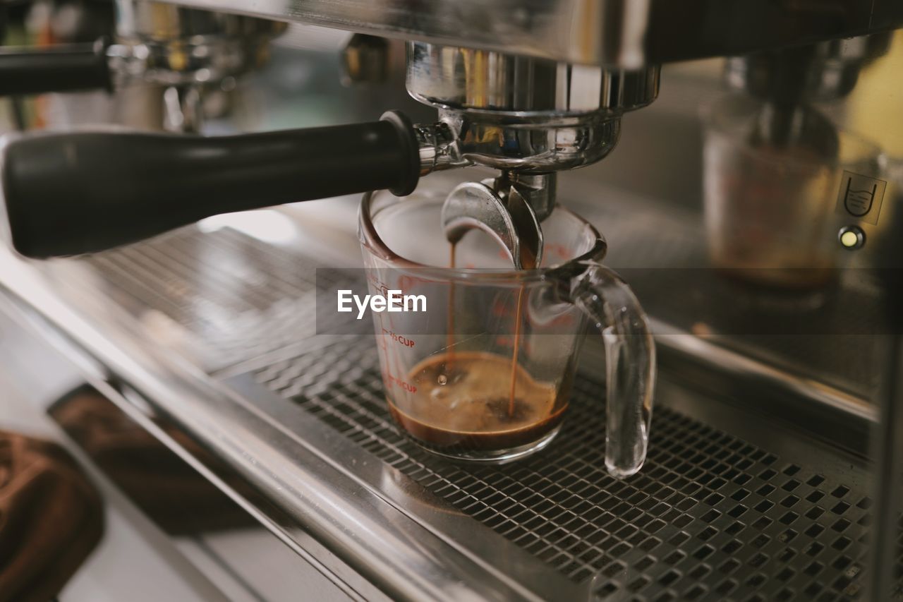 CLOSE-UP OF COFFEE POURING IN CAFE