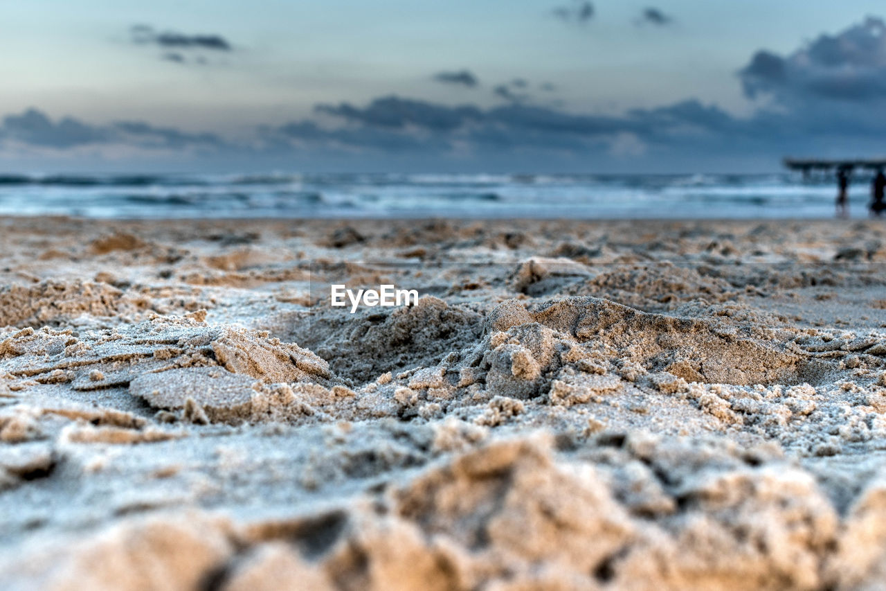 Close-up of sea shore against sky