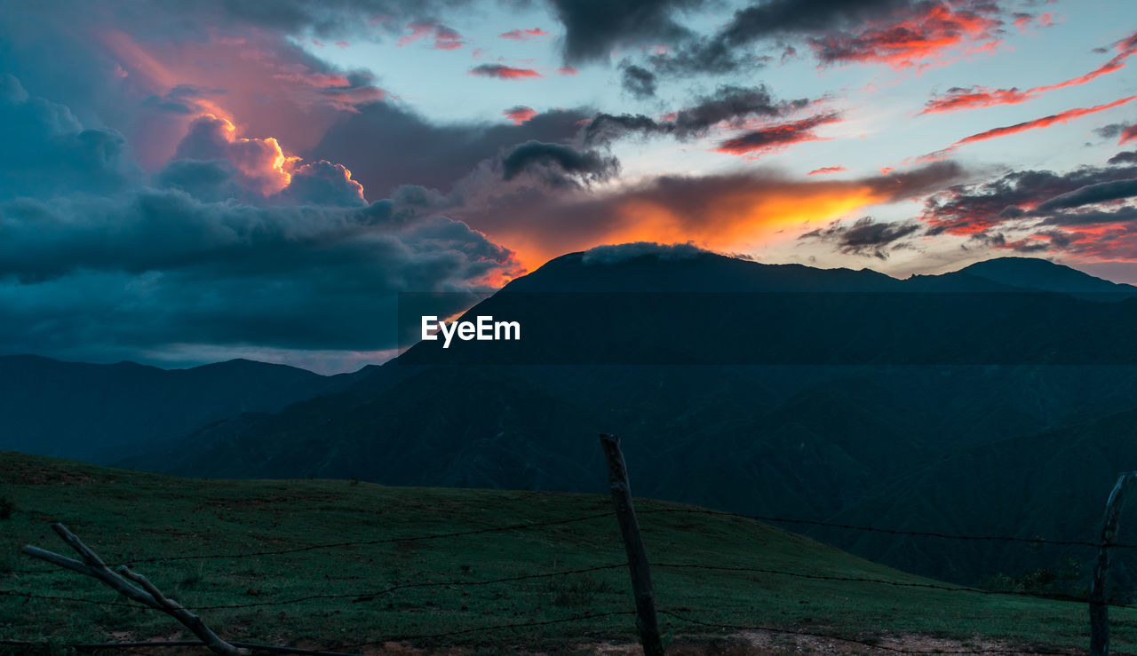 SCENIC VIEW OF DRAMATIC SKY OVER MOUNTAINS