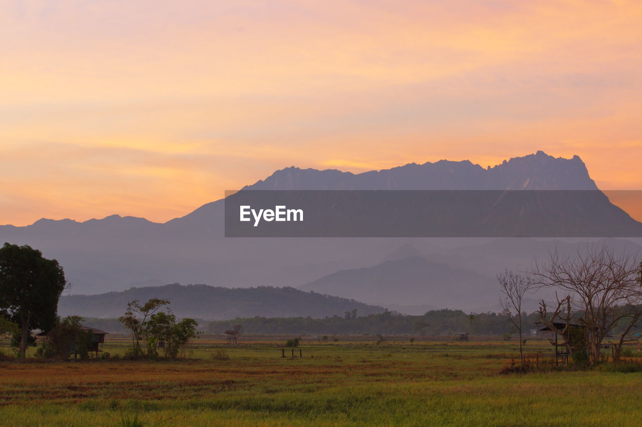 SCENIC VIEW OF MOUNTAINS AGAINST SKY DURING SUNSET