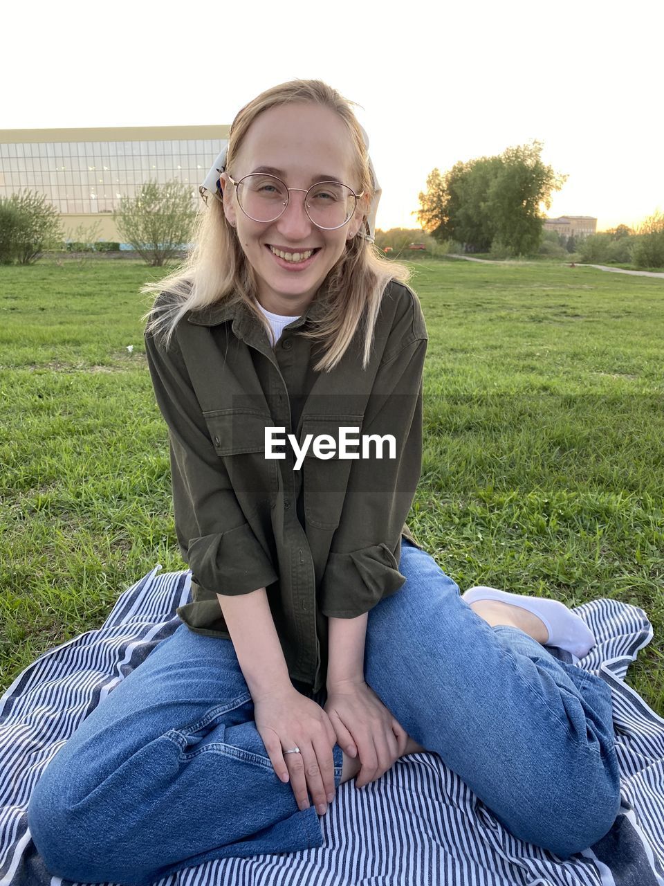 Portrait of teenage girl sitting on field