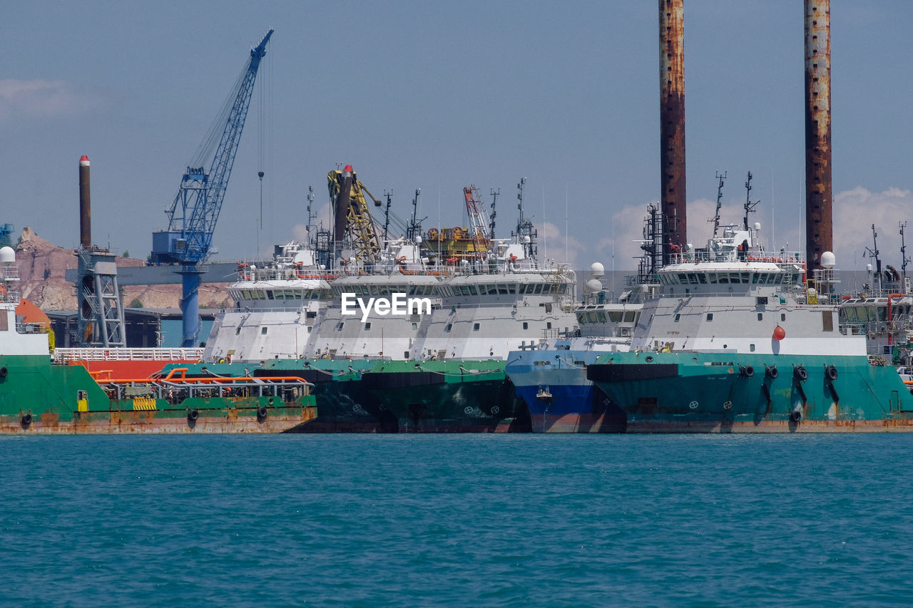 Commercial dock by sea against sky