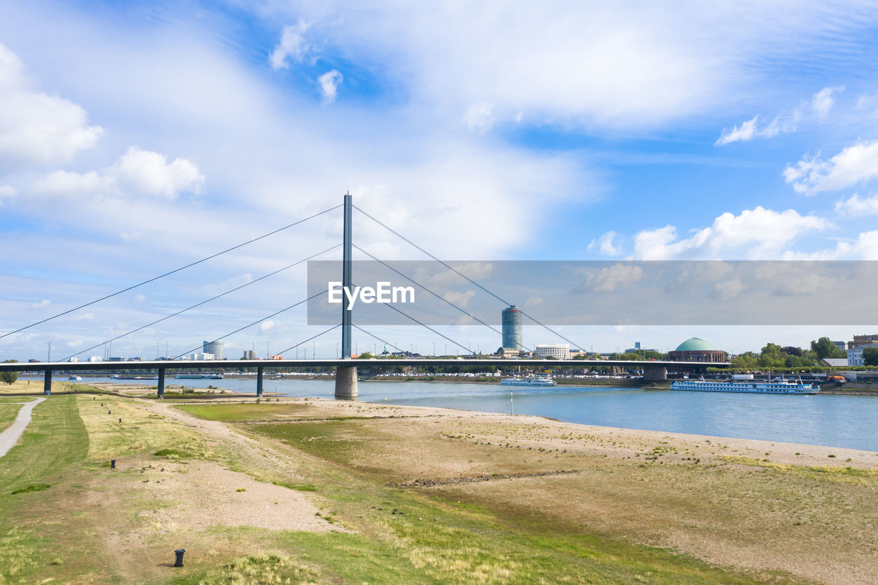 VIEW OF SUSPENSION BRIDGE OVER RIVER