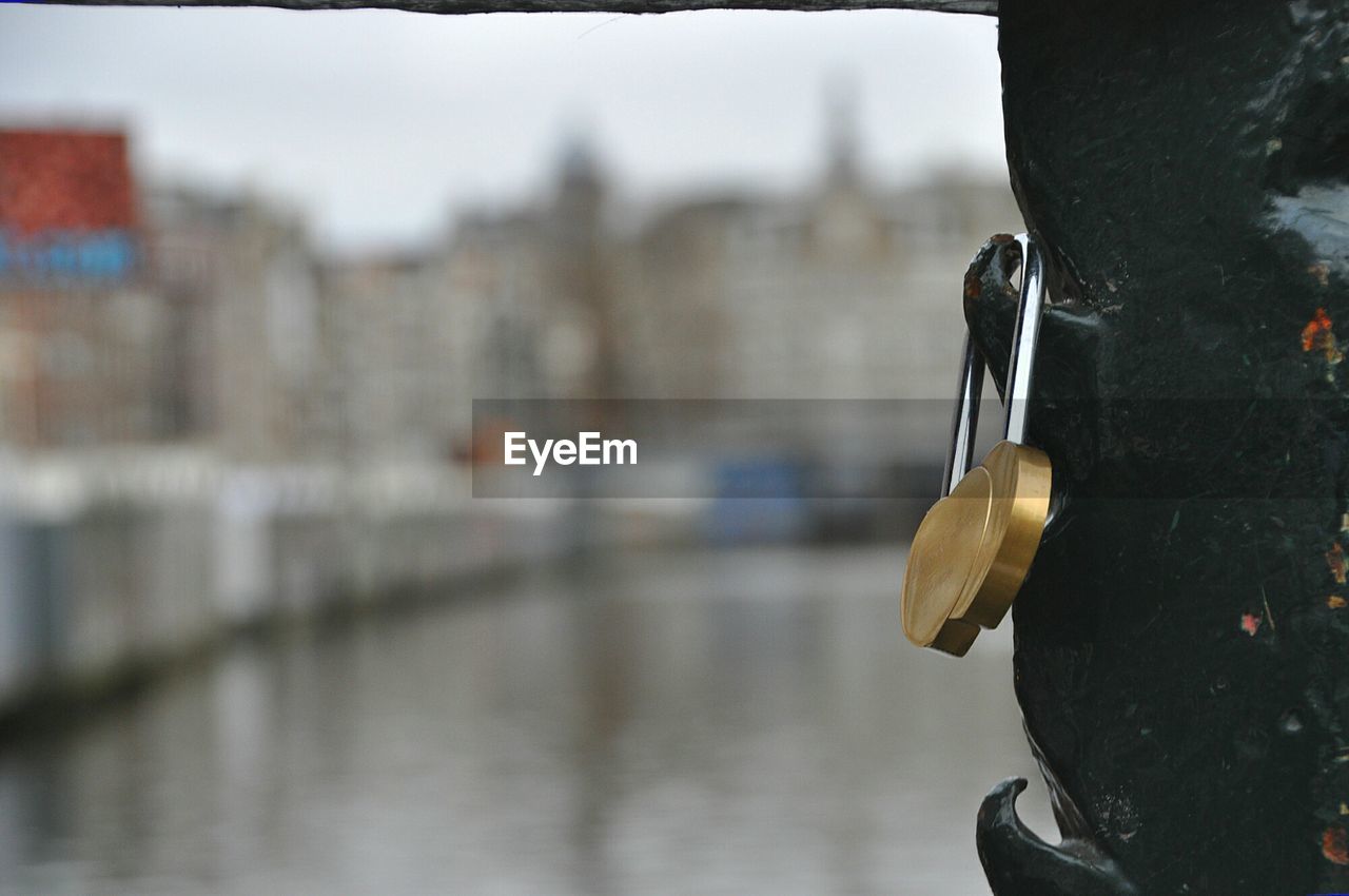 Detail shot of padlock against blurred river