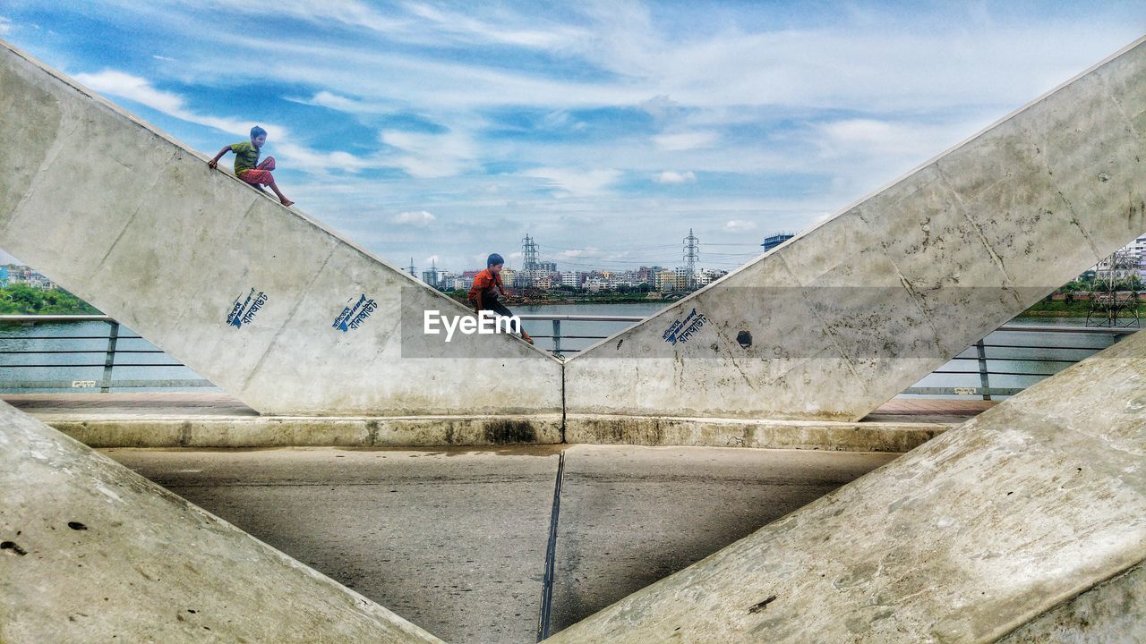 LOW ANGLE VIEW OF PEOPLE WALKING ON STAIRCASE