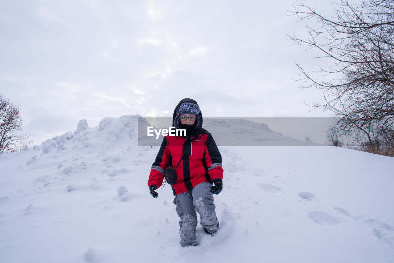 Kid on snow hill