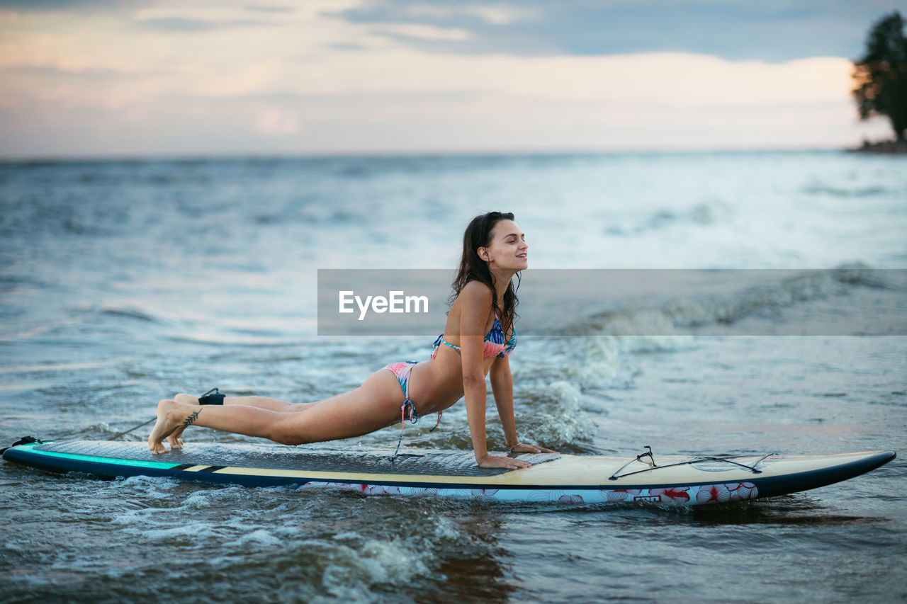 FULL LENGTH OF WOMAN ON SEA