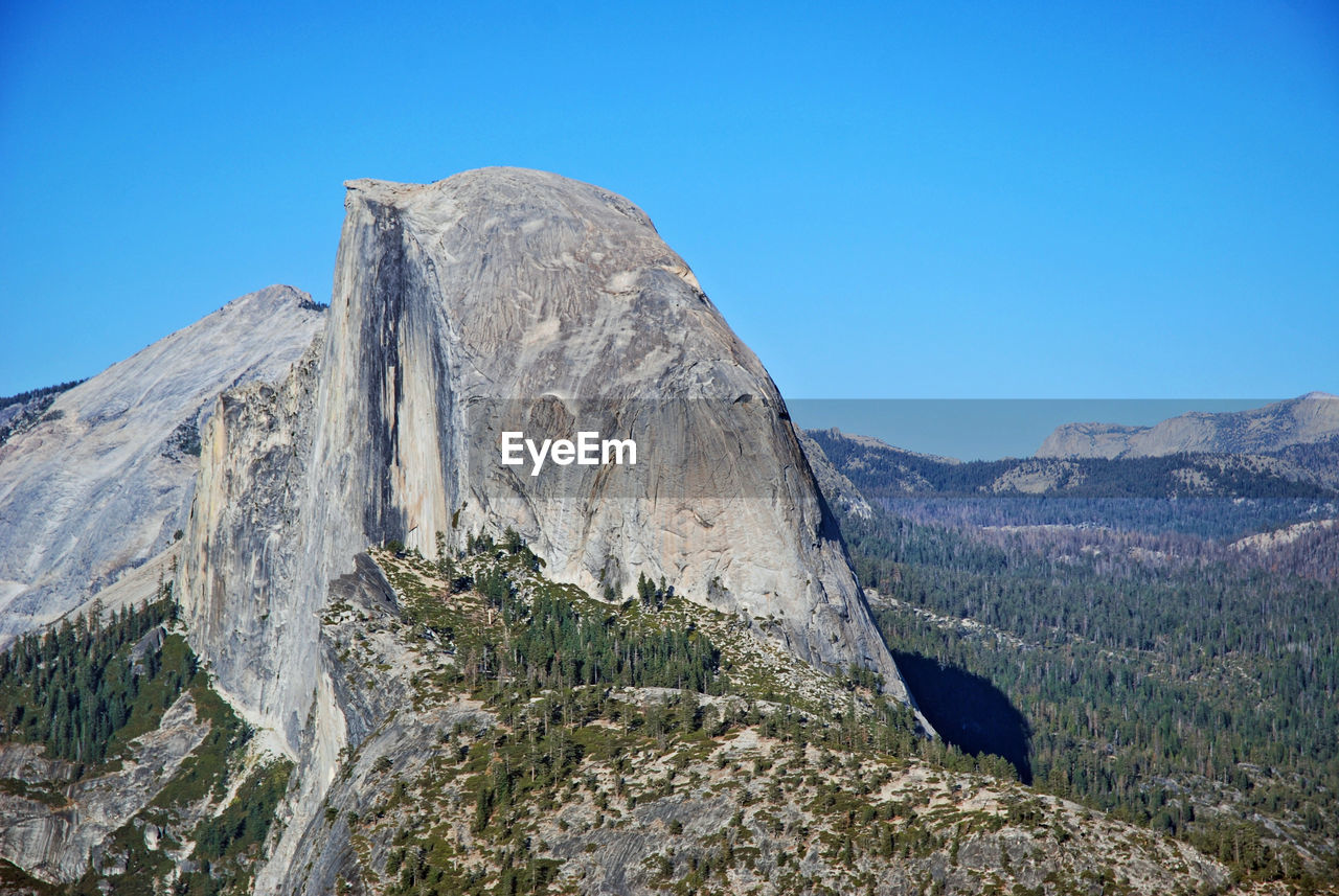 Scenic view of mountains against clear blue sky