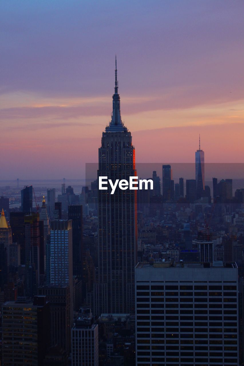 View of buildings in city at sunset