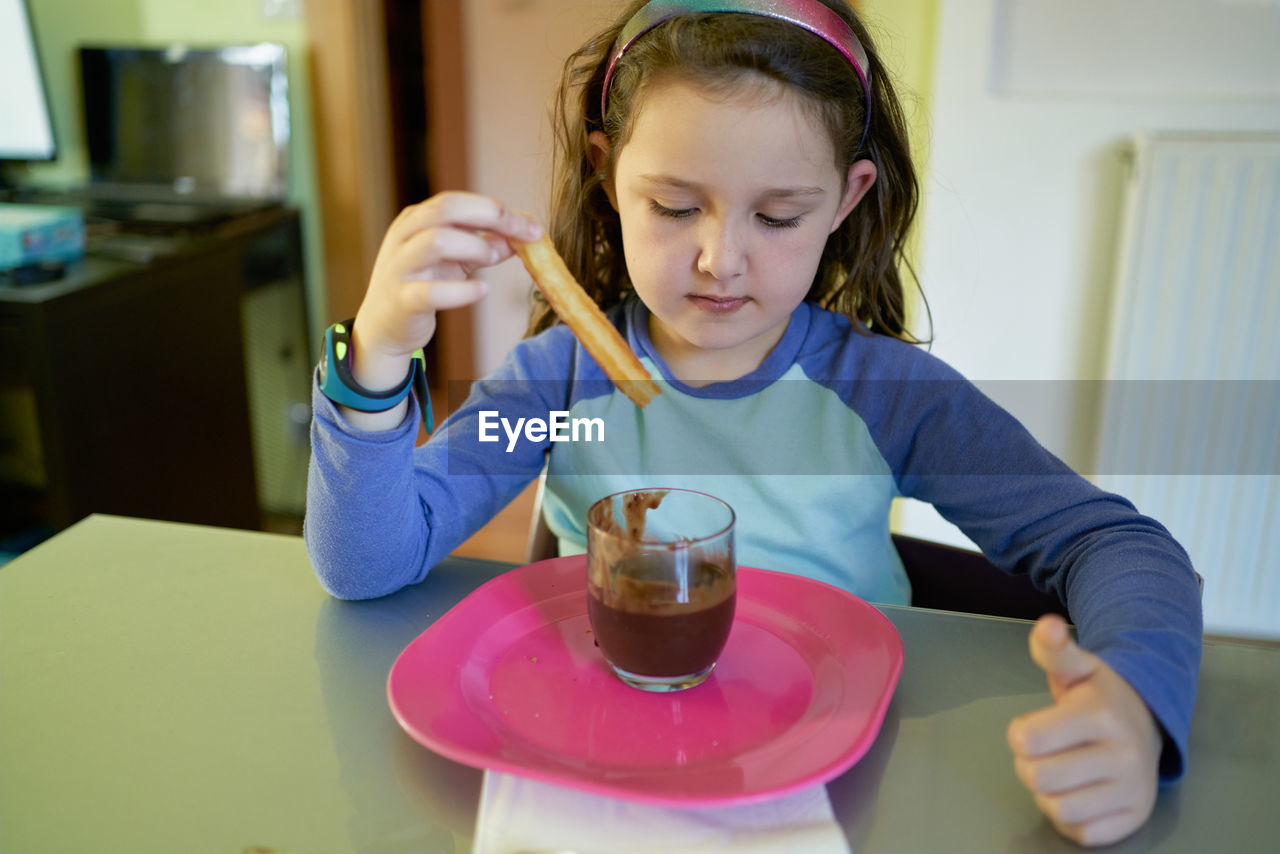 Little girl eating chocolate dessert